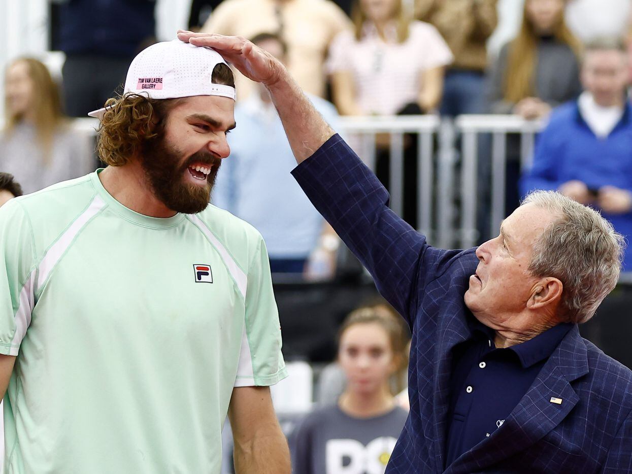 Former President George W. Bush acknowledges Reilly Opelka’s height before before the start...
