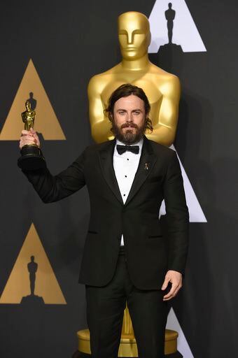 Casey Affleck poses in the press room with the award for best actor in a leading role for...