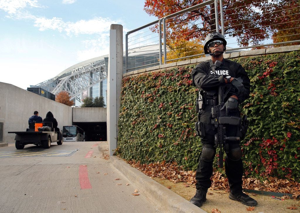 An armed Arlington SWAT officer stands guard at the AT&T Stadium tunnel entrance before the...
