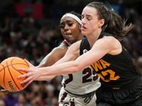 South Carolina guard Raven Johnson (25) fights for a rebound with Iowa guard Caitlin Clark...