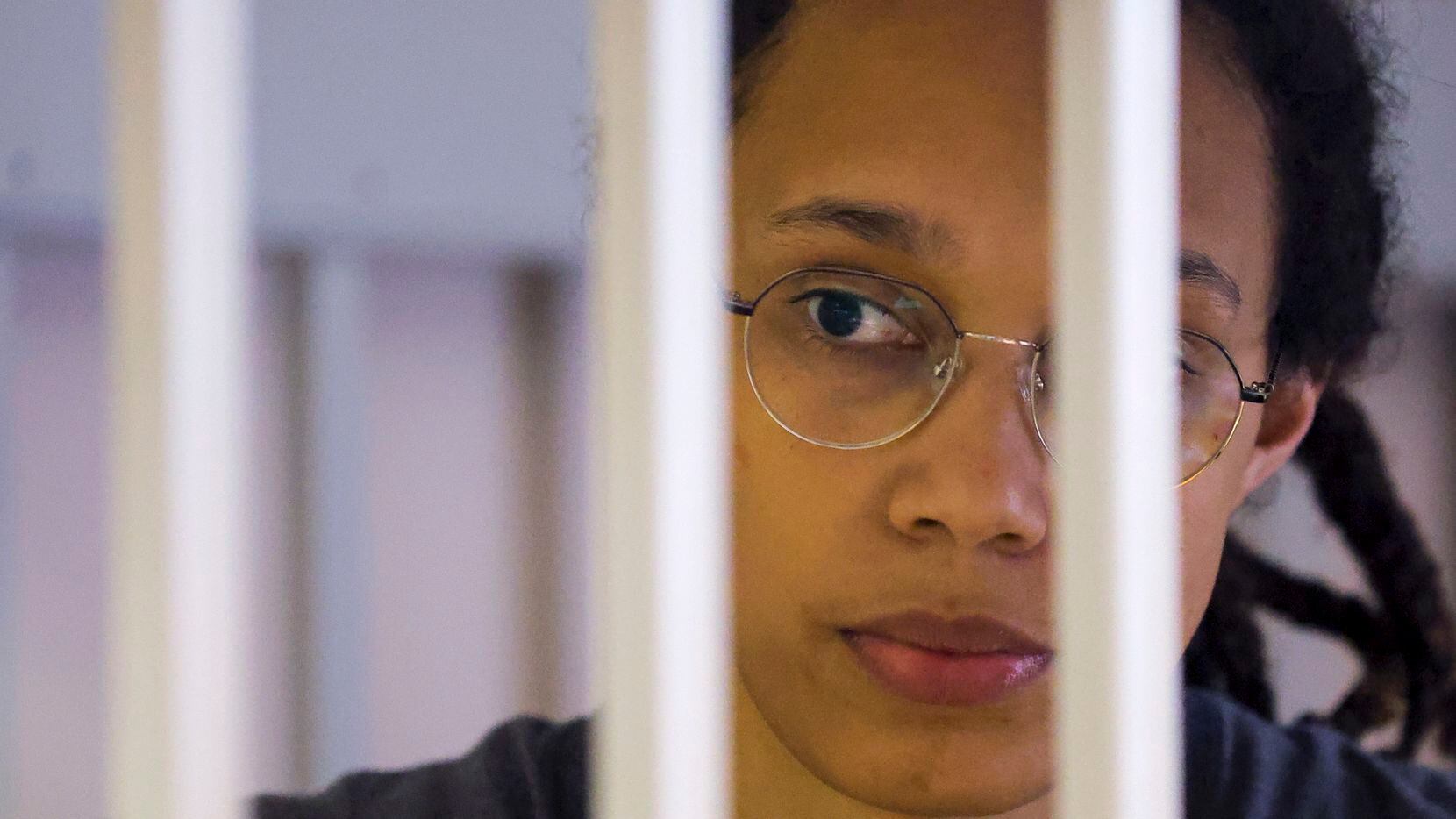 US Basketball player Brittney Griner looks through bars as she listens to the verdict...