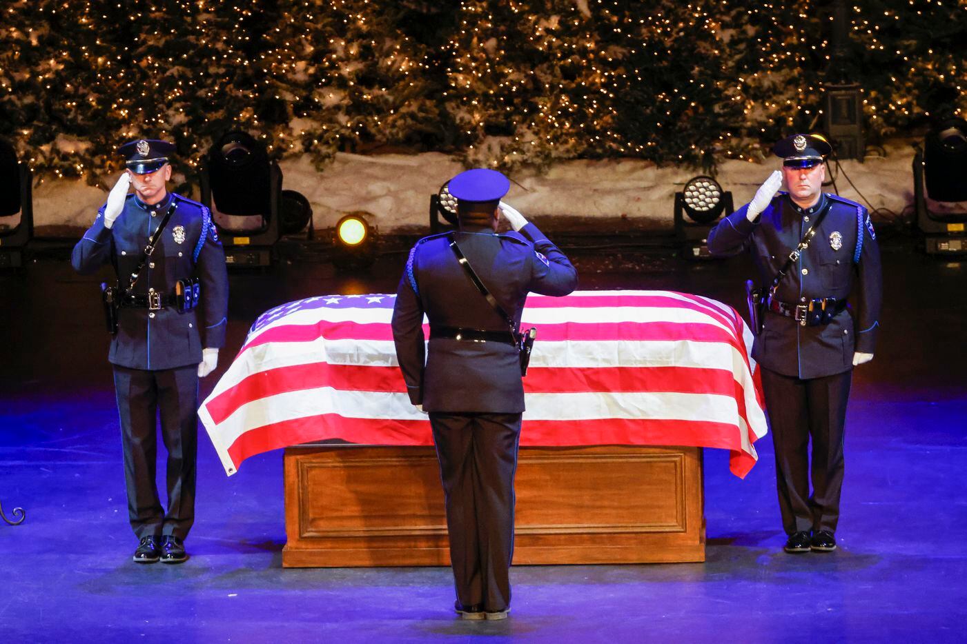 Mesquite police officers salute the casket of slain Mesquite police officer Richard Houston...