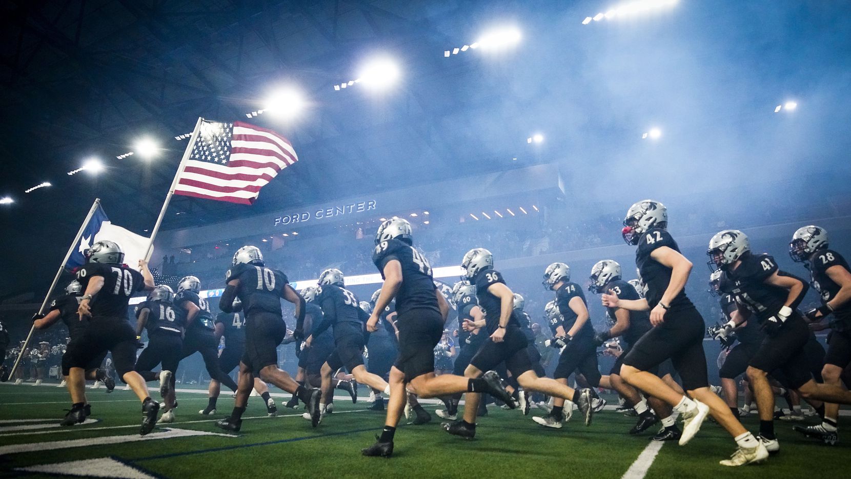 Denton Guyer players take the field a Class 6A Division II area-round high school football...