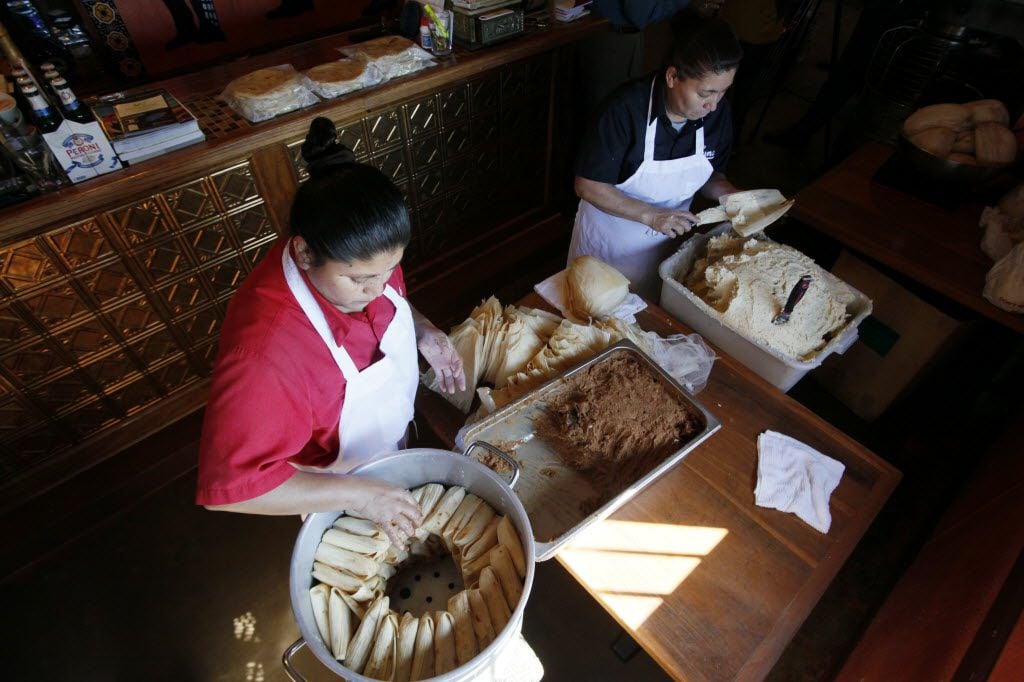 Maria Milan and Armandina Flores prepare tamales to sell for the holidays at Luna's Tortilla...