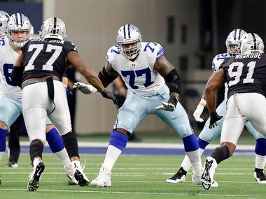 Dallas Cowboys offensive tackle Tyron Smith (77) started against the Las Vegas Raiders in the first quarter at AT&T Stadium in Arlington, November 25, 2021.