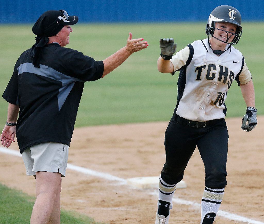 The Colony third baseman Madison Hirsch (18) is congratulated by her head coach, Deana...
