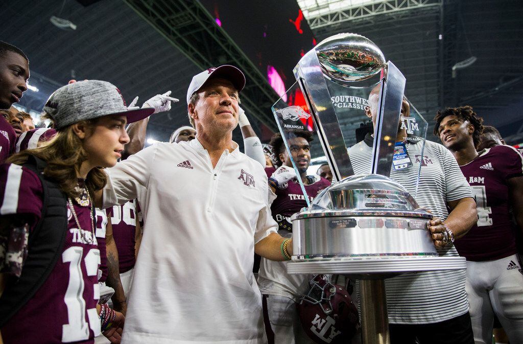 Texas A&M Aggies head coach Jimbo Fisher accepts the Southwest Classic trophy after a 24-17...