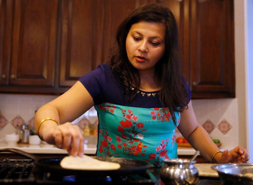 Sapna Punjabi-Gupta prepares to flip a roti at her home in Irving.