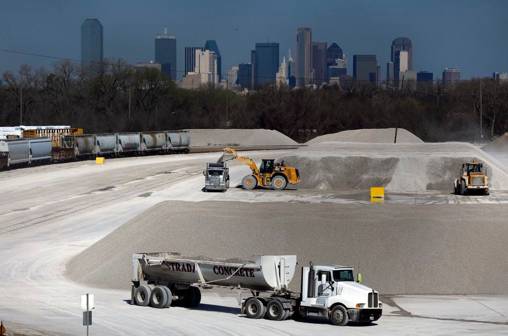 Trucks are loaded with aggregate at Martin Marietta's Miller Yard across the Union Pacific...