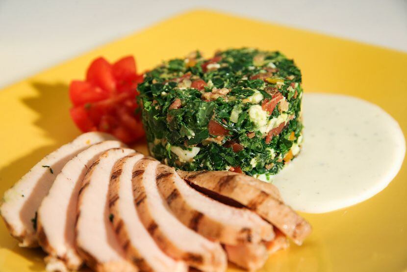 Kale Cobb tower with a fan of grilled chicken breast 