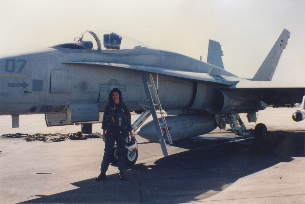 Pilot Tammie Jo Shults in front of a Navy jet.