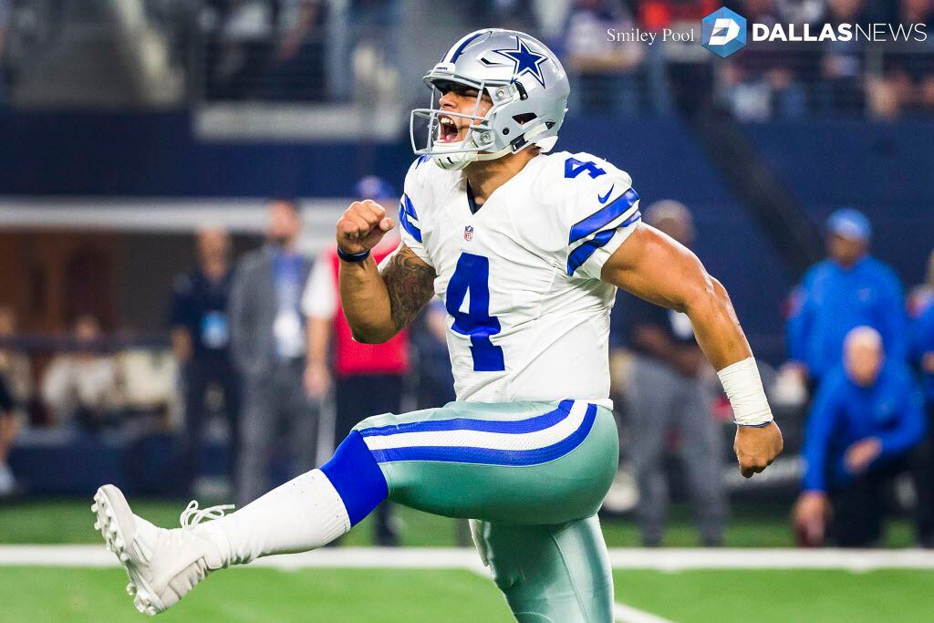 Dallas Cowboys quarterback Dak Prescott (4) celebrates after throwing a touchdown pass to...
