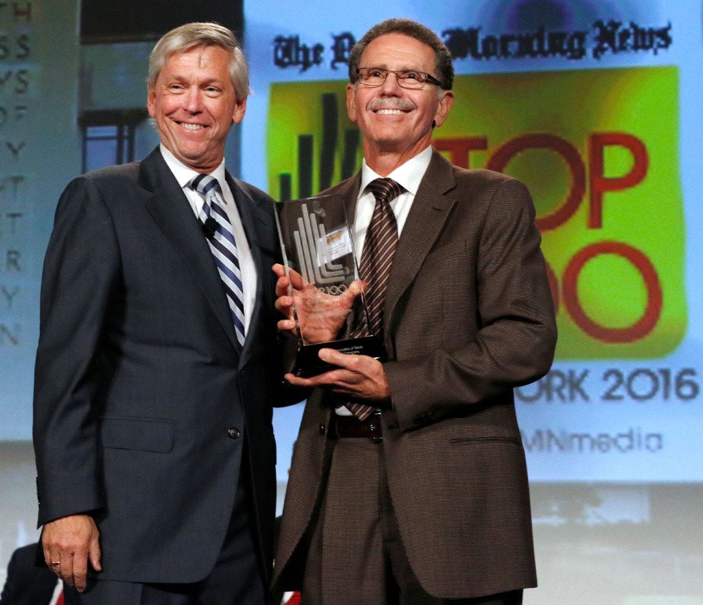 Jim Moroney, Publisher and CEO of the Dallas Morning News, left, poses with Dr. Henry...