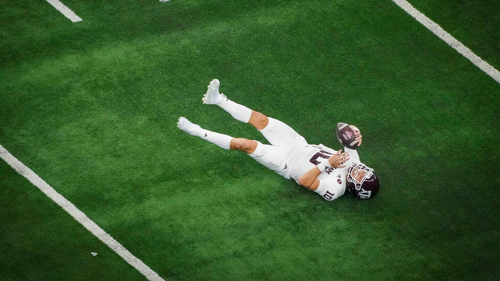 Texas A&M quarterback Zach Calzada (10) slips to the turf during the second half of an NCAA...