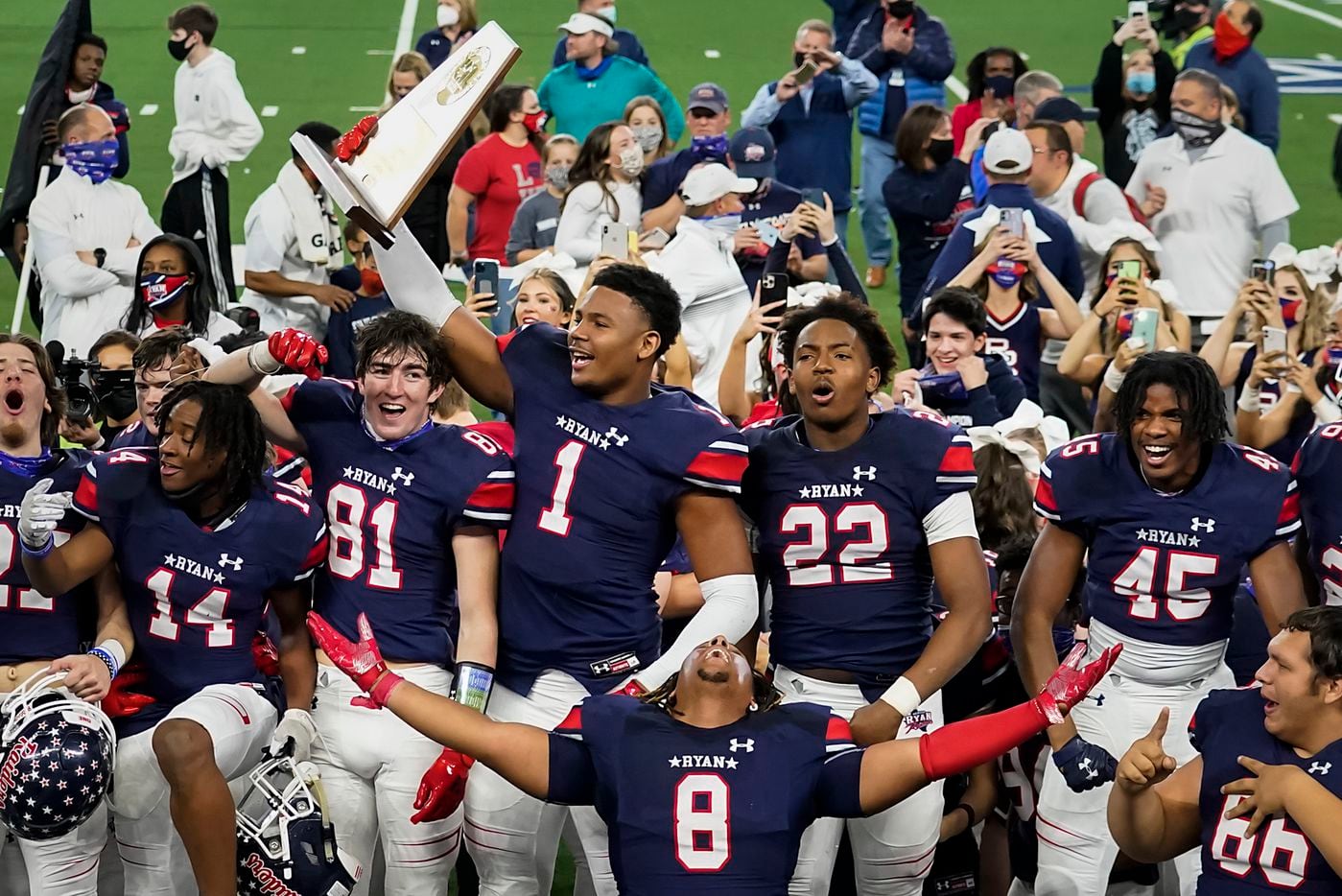 Denton Ryan’s Ja'Tavion Sanders (1) hoists the championship trophy as players celebrate a 59-14 victory over Cedar Park to win the Class 5A Division I state football championship game at AT&T Stadium on Friday, Jan. 15, 2021, in Arlington, Texas. (Smiley N. Pool/The Dallas Morning News)