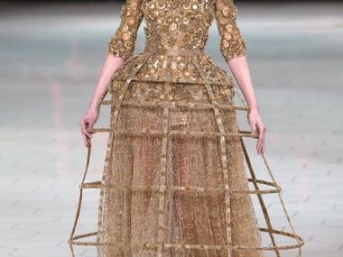 A model presents a creation for Alexander McQueen during the Spring/Summer 2013...