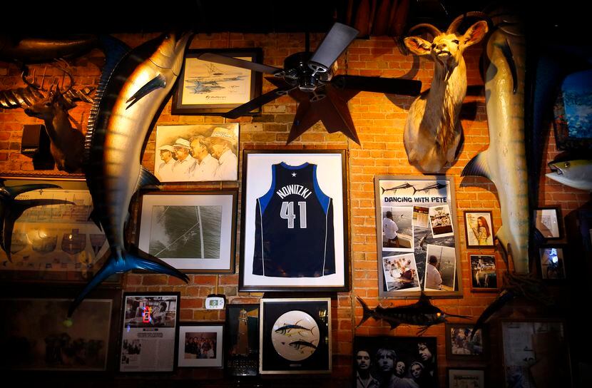  A jersey of Dallas Mavericks Dirk Nowitzki hangs between a pair of mounted swordfish at St....