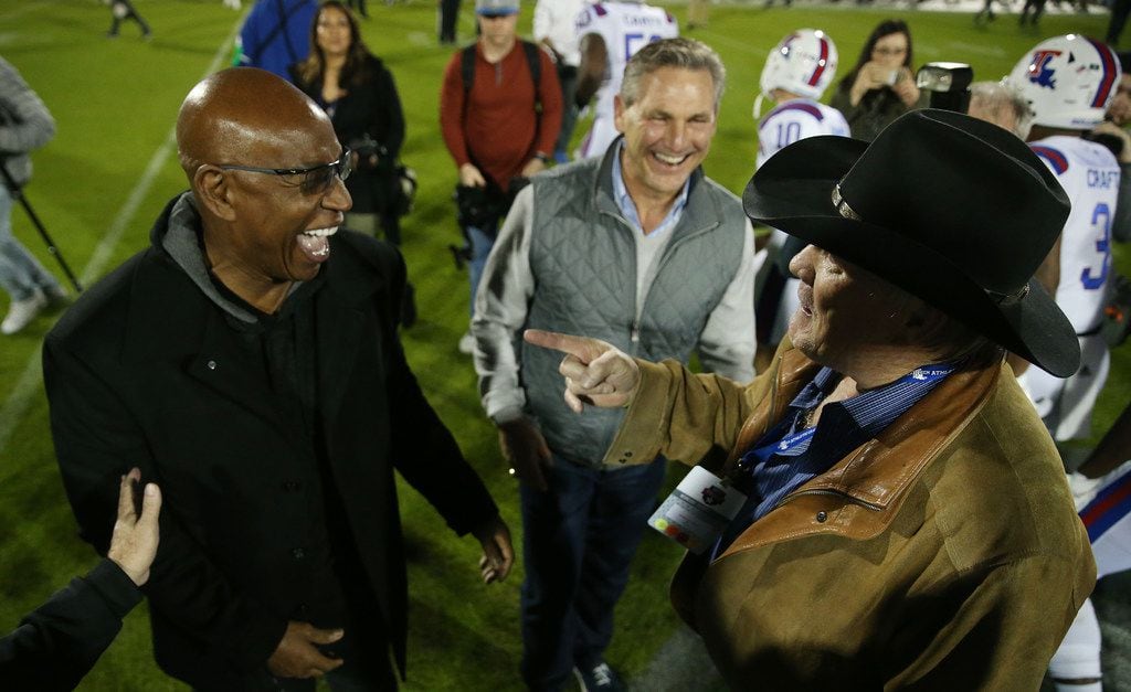 FILE - Eric Dickerson (left), Craig James (middle) and Terry Bradshaw (right) speak before the Frisco Bowl between Louisiana Tech and SMU at Toyota Stadium in Frisco on Wednesday Dec. 20, 2017. (Andy Jacobsohn/The Dallas Morning News)