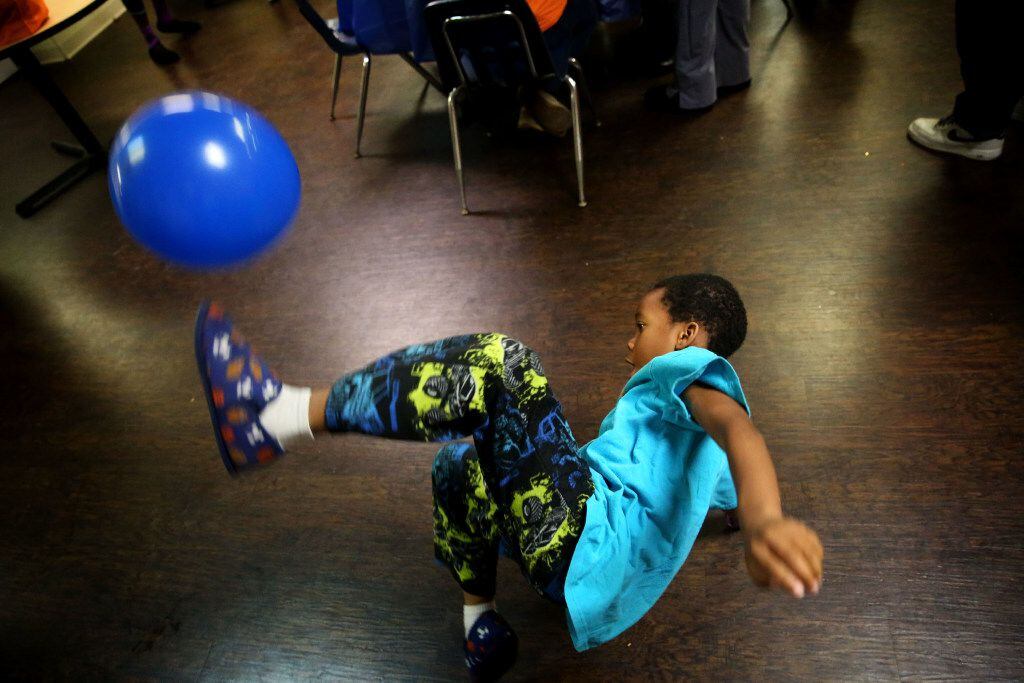 Jeremiah Ross, 6, plays with a balloon during a birthday celebration hosted by The Birthday...