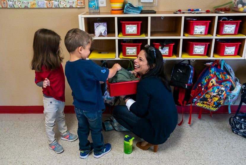 Director Jennifer Granadillo helps Rhys Yanez, 4, find his jacket in a classroom on Nov. 18,...