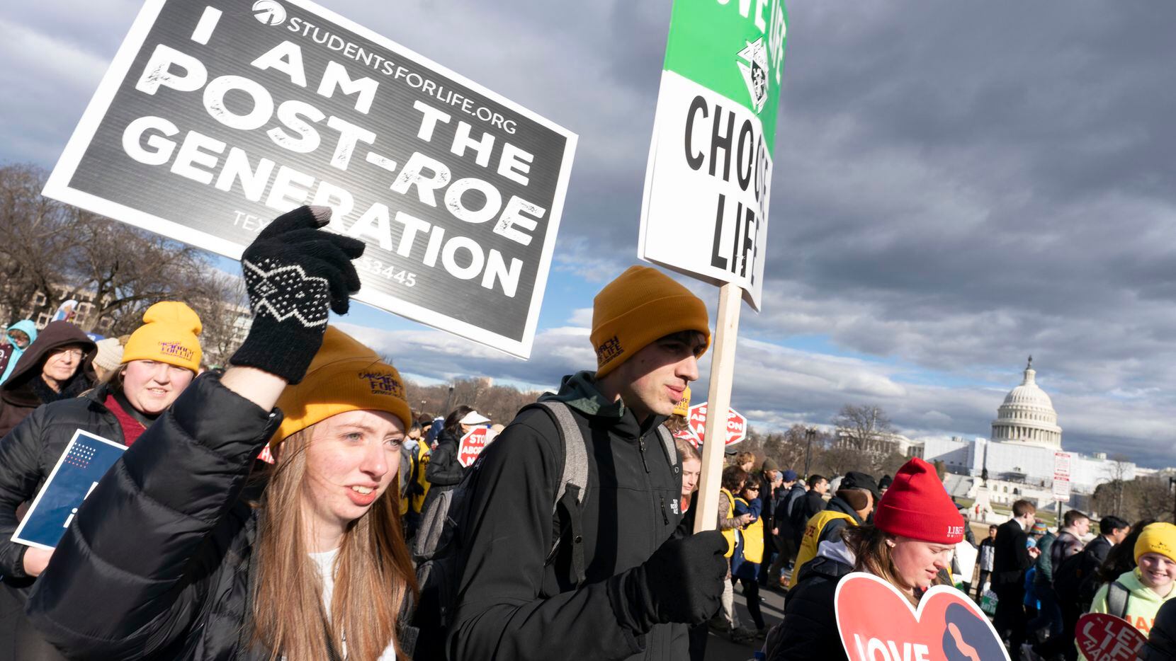 With the U.S. Capitol in the background, anti-abortion demonstrators march toward the U.S....