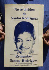  An old poster of Santos Rodriguez from 1993 displays his image for a community memorial.