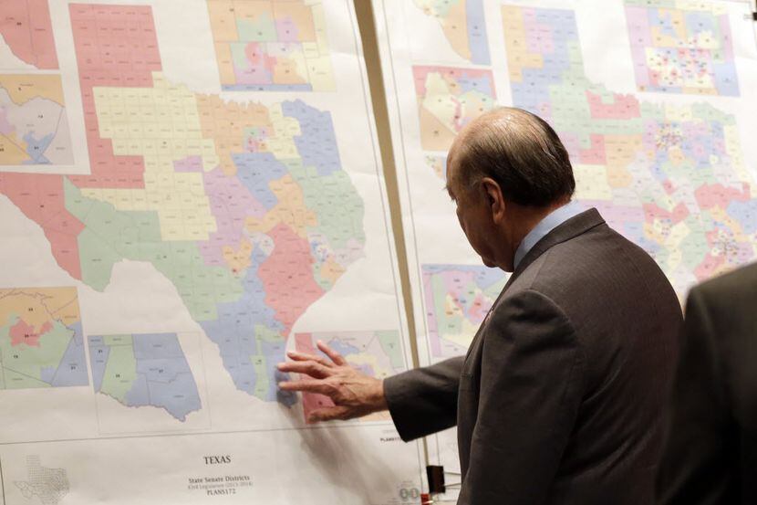 FILE - In this May 30, 2013 file photo, Texas state Sen. Juan "Chuy" Hinojosa looks at maps...