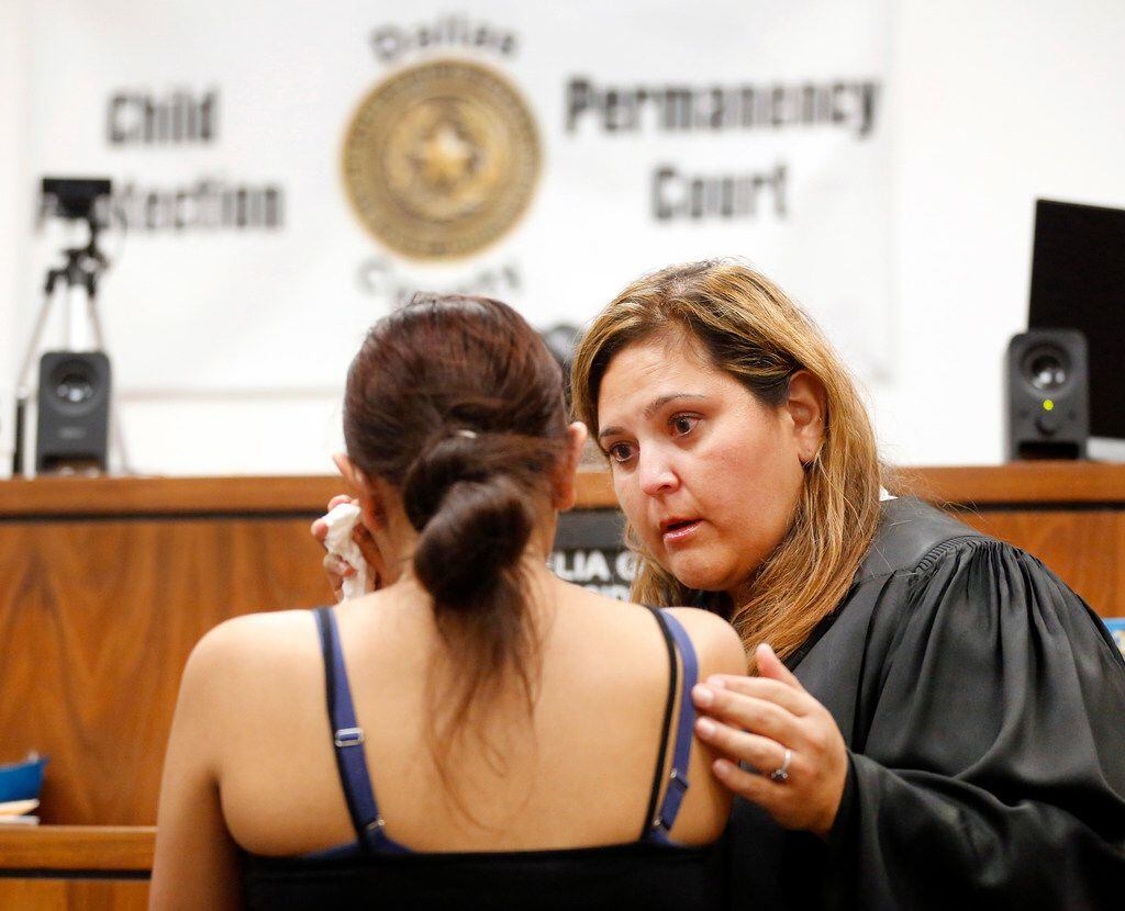 Associate Judge Delia Gonzales  comes down from her bench to comfort a pregnant teen who was overcome with an emotion in her Child Protection and Permanency Court at the George Allen Courthouse in Dallas, July 26, 2019.  Gonzales was recently appointed to run the unusual court — the second of its kind in the nation. She hears from foster kids and their legal support team so they can be placed in safe, permanent homes.
