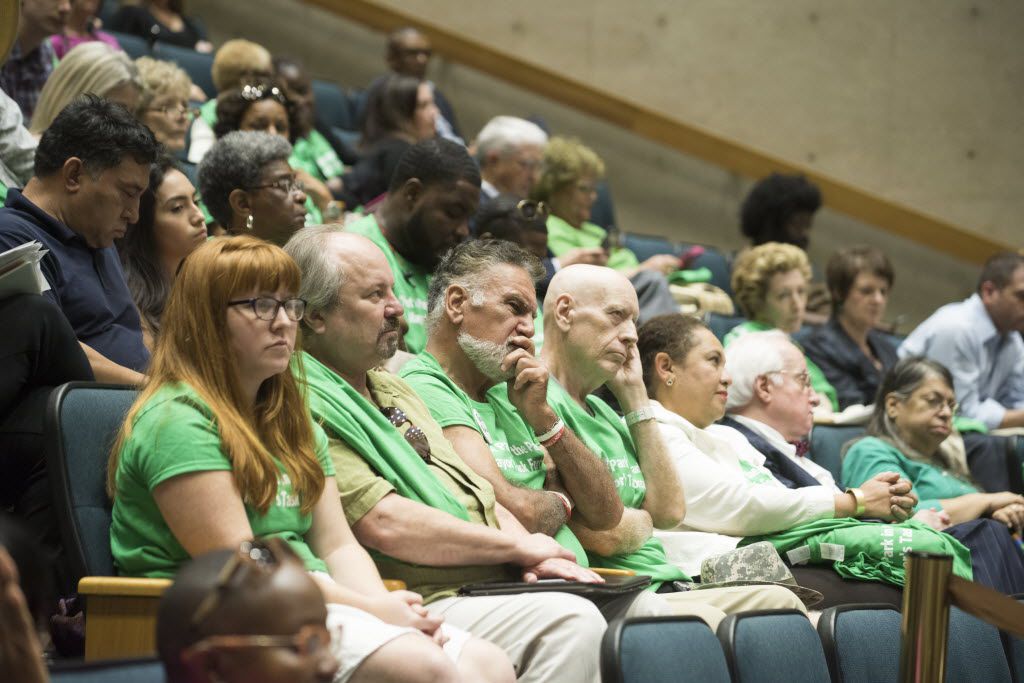 People opposed to Walt Humann's plan wore green shirts to the council meeting Monday.