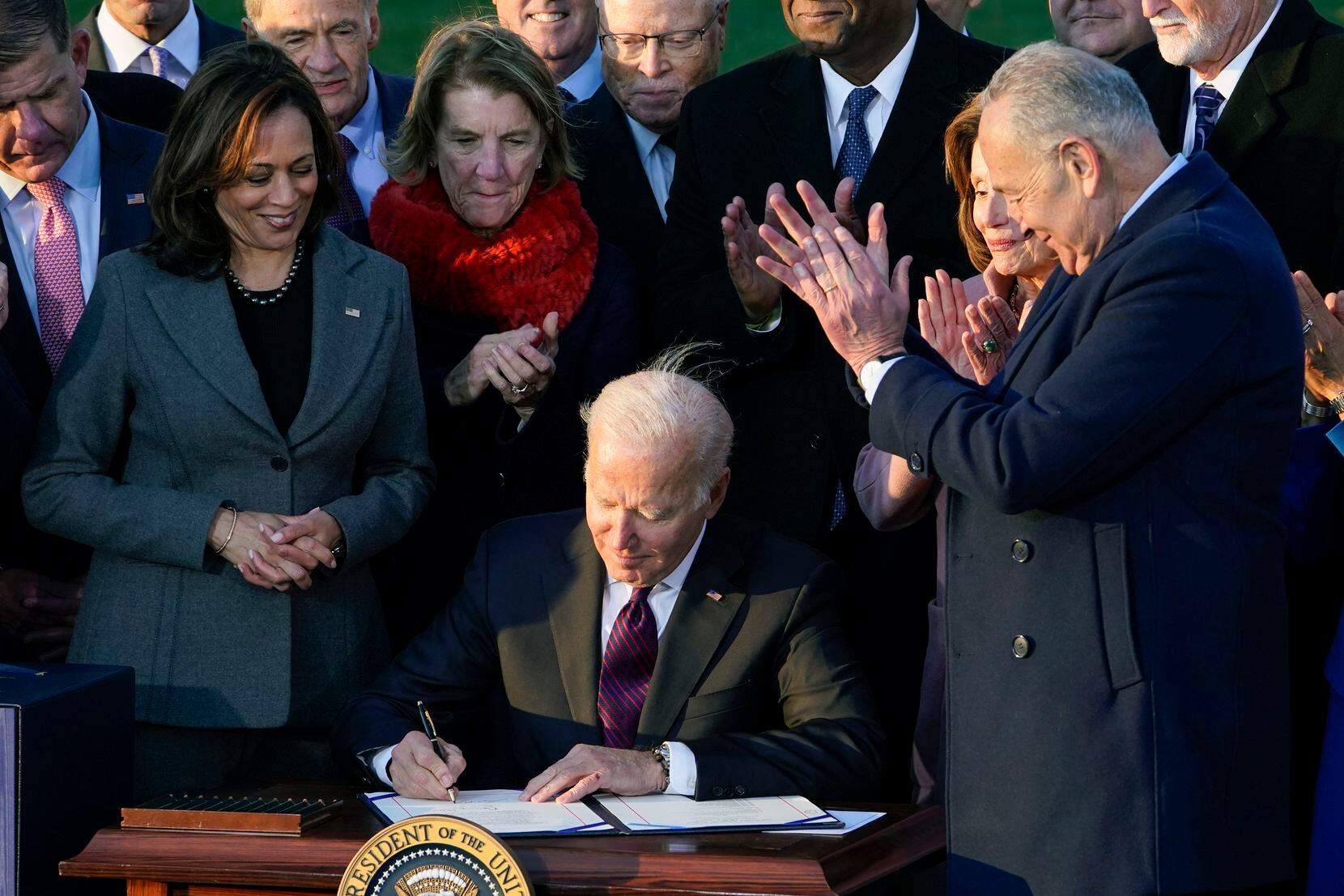 FILE - President Joe Biden signs the $1.2 trillion bipartisan infrastructure bill into law...