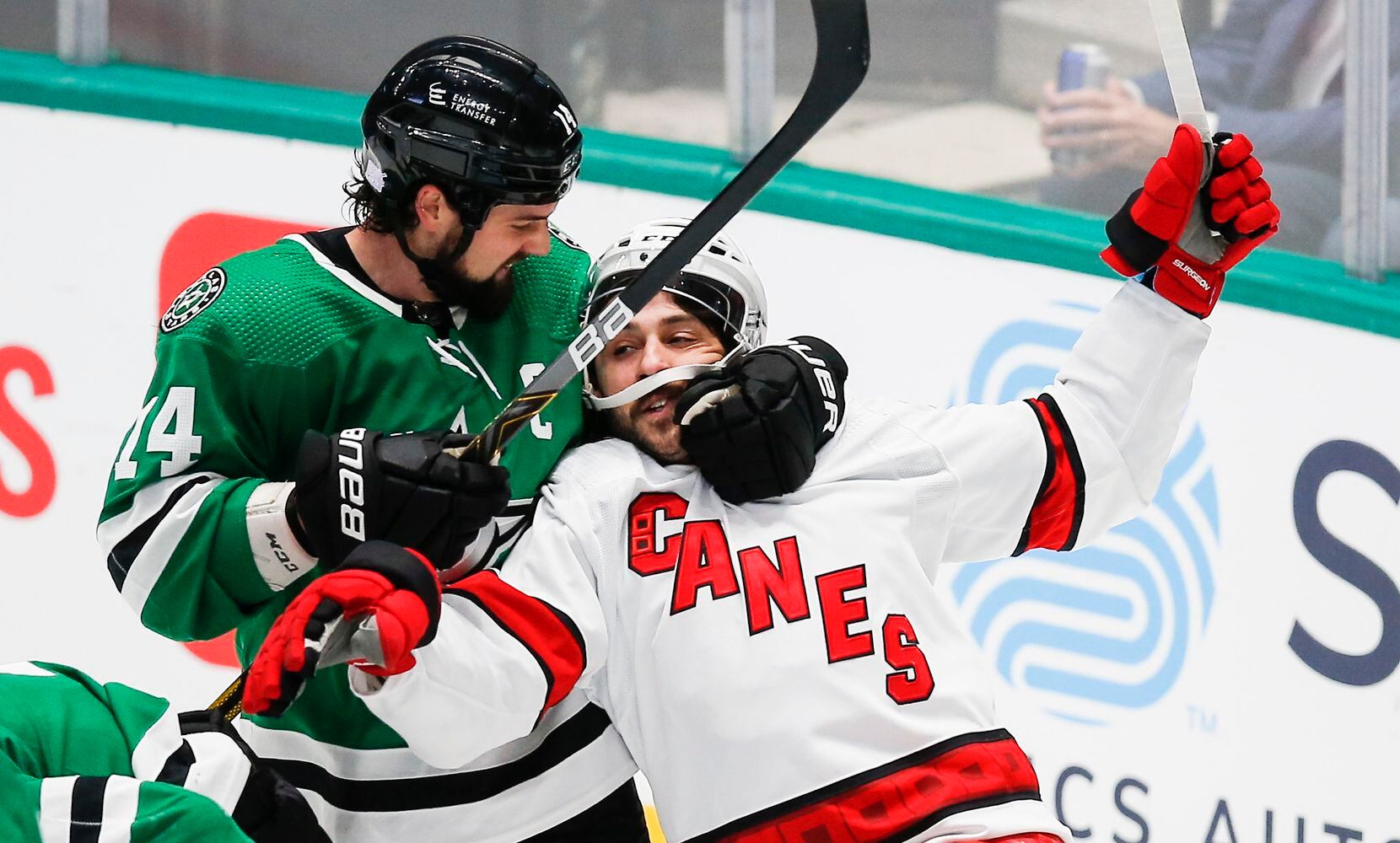 Dallas Stars forward Jamie Benn (14) pulls Carolina Hurricanes forward Vincent Trocheck (16) off of  defenseman Miro Heiskanen, not pictured, after a stoppage of play during the first period of an NHL hockey game in Dallas, Tuesday, November 30, 2021. (Brandon Wade/Special Contributor)