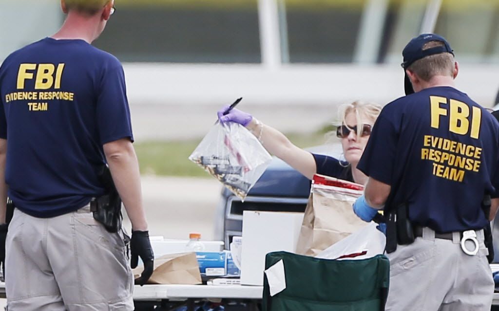 FBI crime scene investigators document evidence outside the Curtis Culwell Center on May 4,...