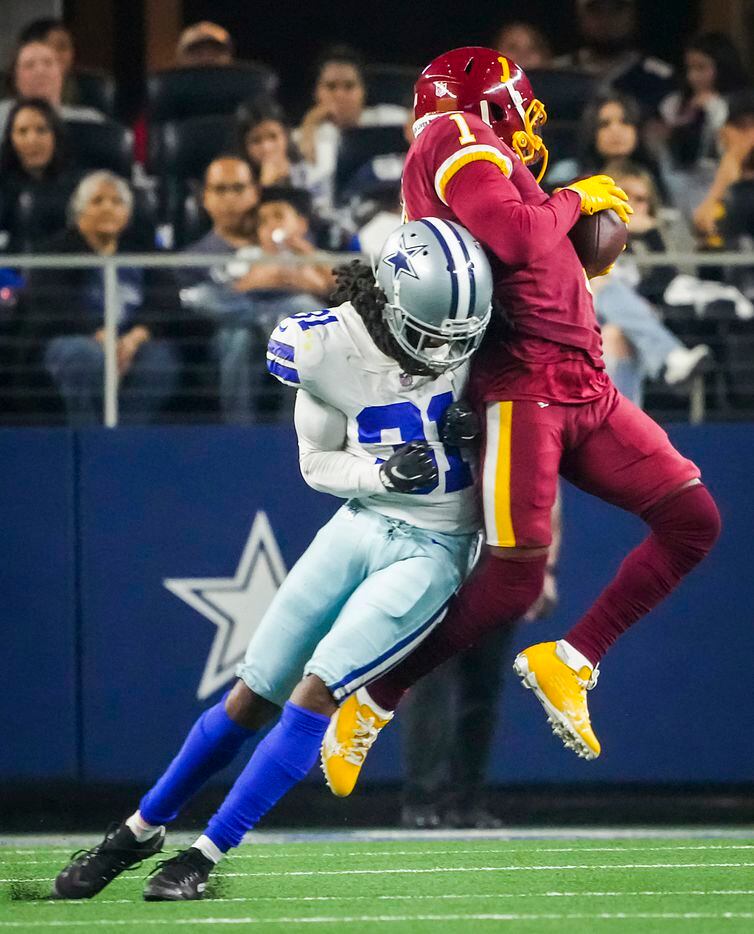Washington Football Team wide receiver DeAndre Carter (1) makes a catch as Dallas Cowboys cornerback Maurice Canady (31) defends during the second half of an NFL football game at AT&T Stadium on Sunday, Dec. 26, 2021, in Arlington. The Cowboys won the game 56-14.