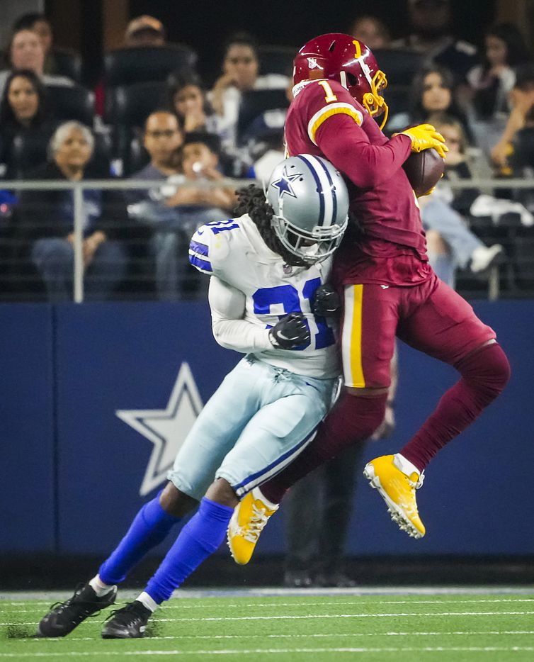 Washington Football Team wide receiver DeAndre Carter (1) makes a catch as Dallas Cowboys cornerback Maurice Canady (31) defends during the second half of an NFL football game at AT&T Stadium on Sunday, Dec. 26, 2021, in Arlington. The Cowboys won the game 56-14.
