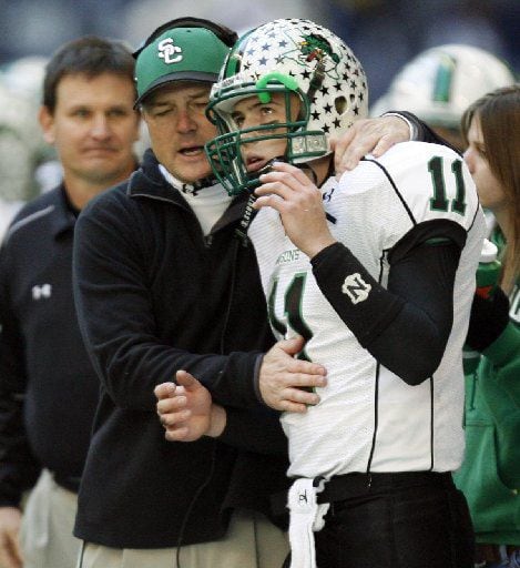 Carroll's head coach Todd Dodge congratulates his son and quarterback Riley...