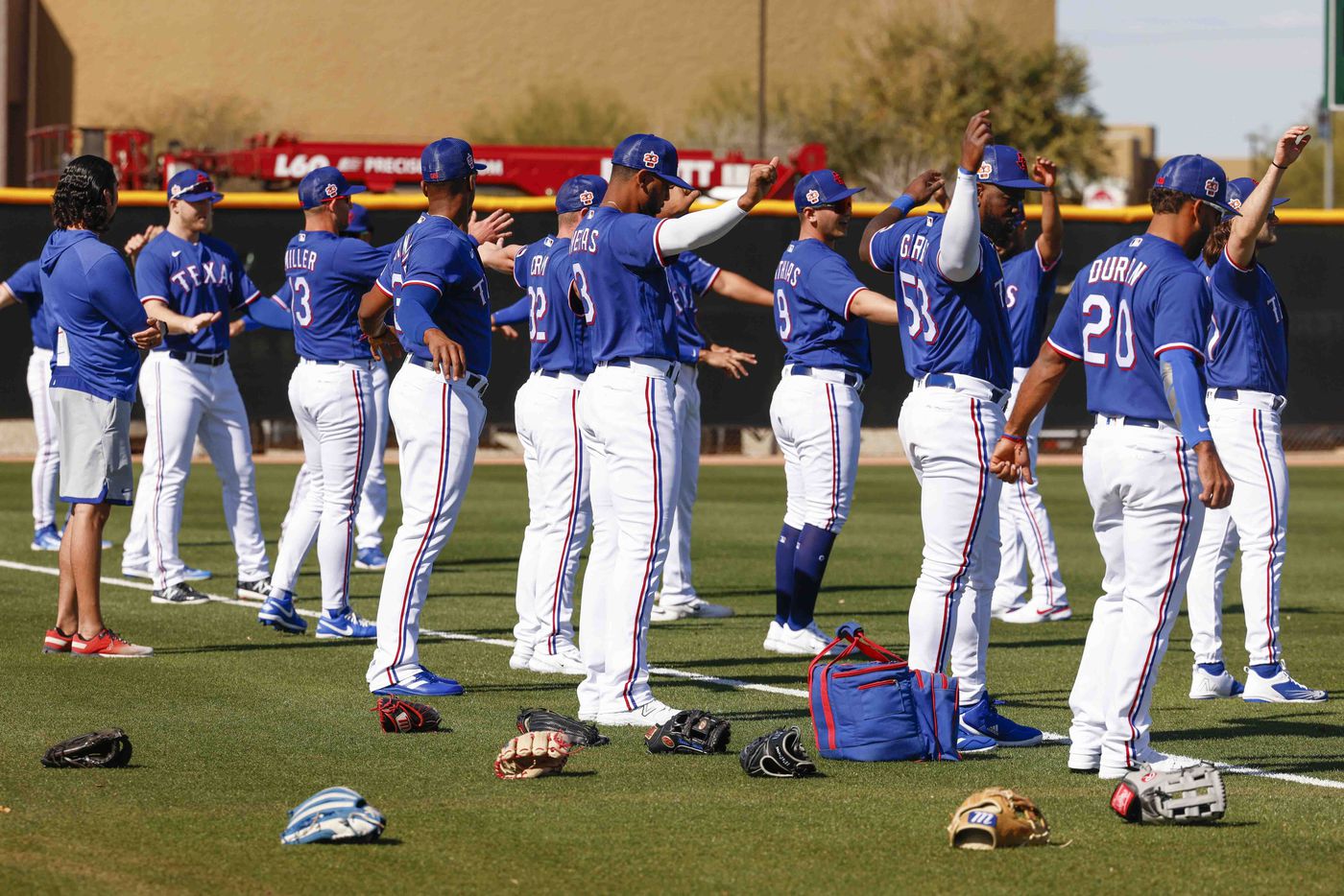 Texas Rangers players warm up ahead of a batting practice during a spring training workout...