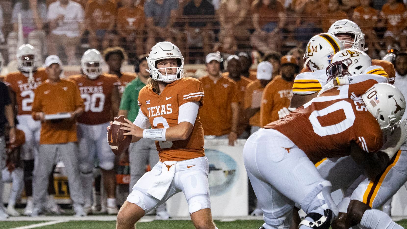 Texas quarterback Quinn Ewers, front left, looks to pass during the first half of an NCAA...