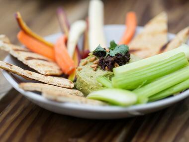 Avocado Hummus with sun-dried tomato relish, toasted sunflower seeds, grilled pita, and...
