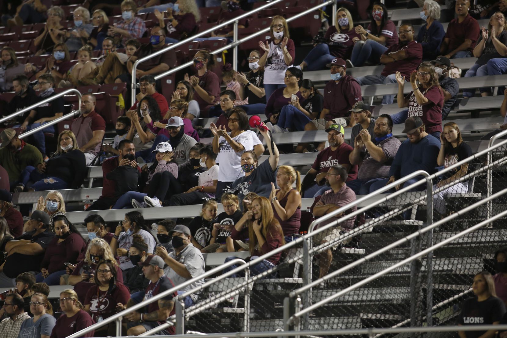Ennis fans react to a second quarter Lions touchdown in their game against Mansfield Summit....