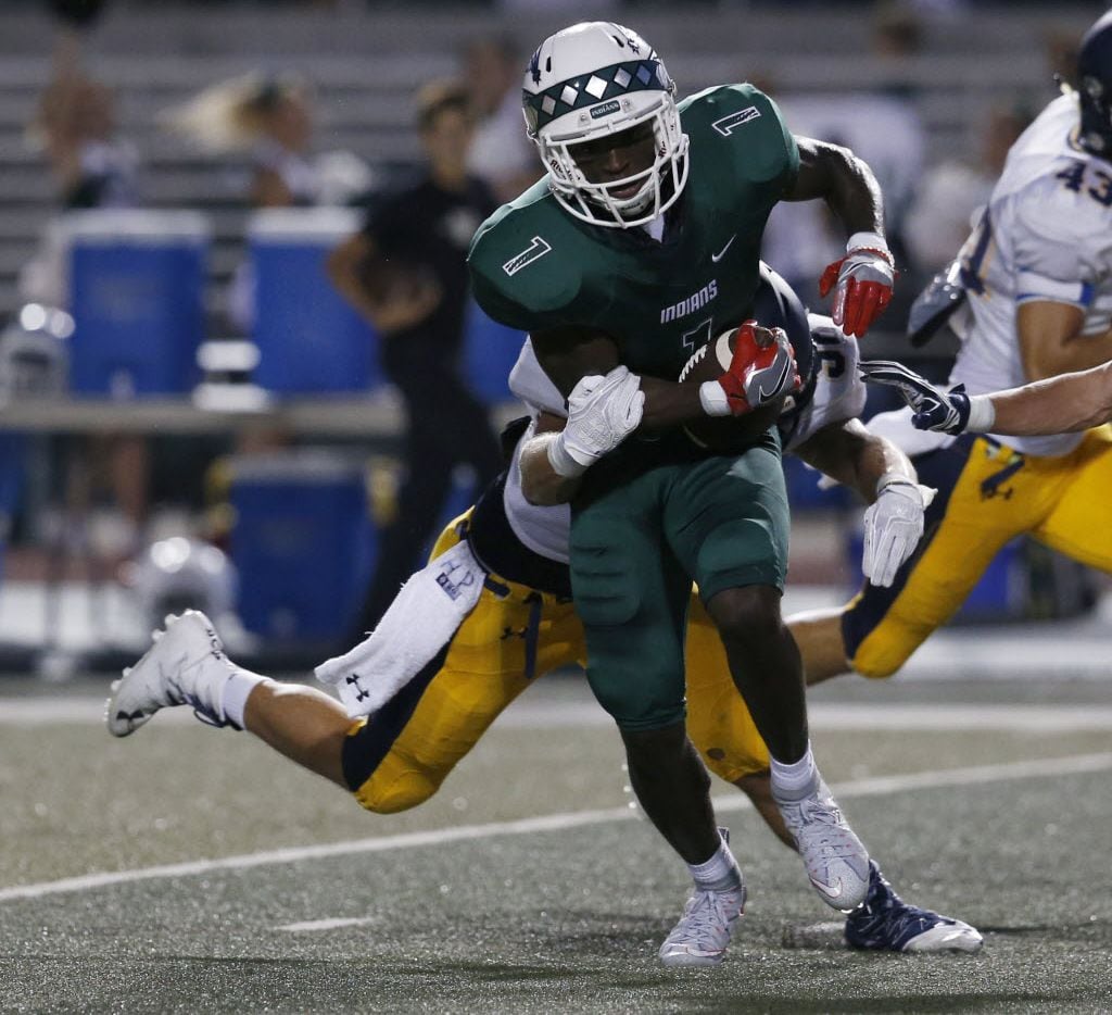 Waxahachie receiver Jalen Reagor (1) is tackled by Highland Park defensive player Bennett...