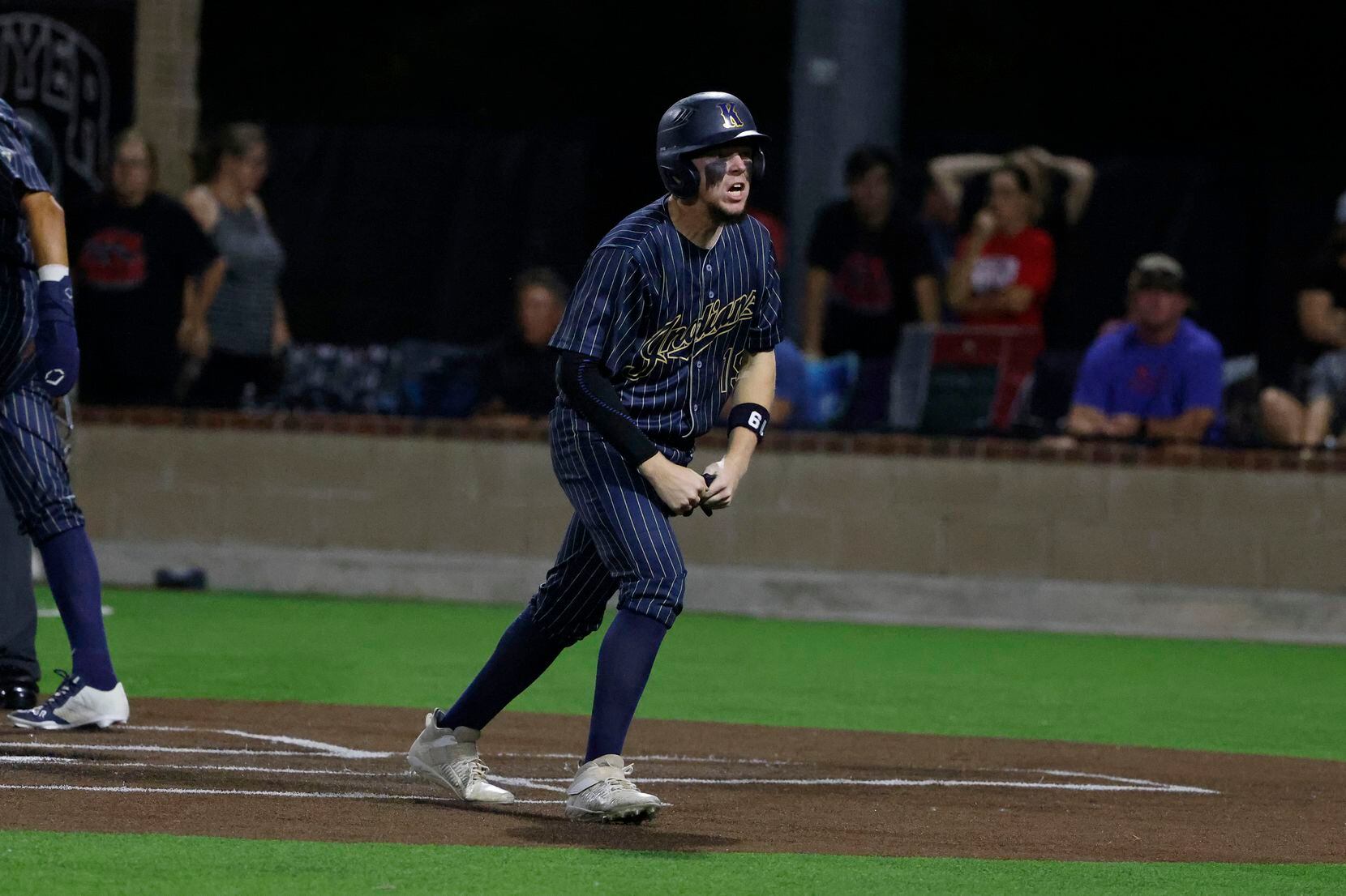 Keller’s Fisher Polydoroff reacts after scoring a run against Flower Mound Marcus during the...