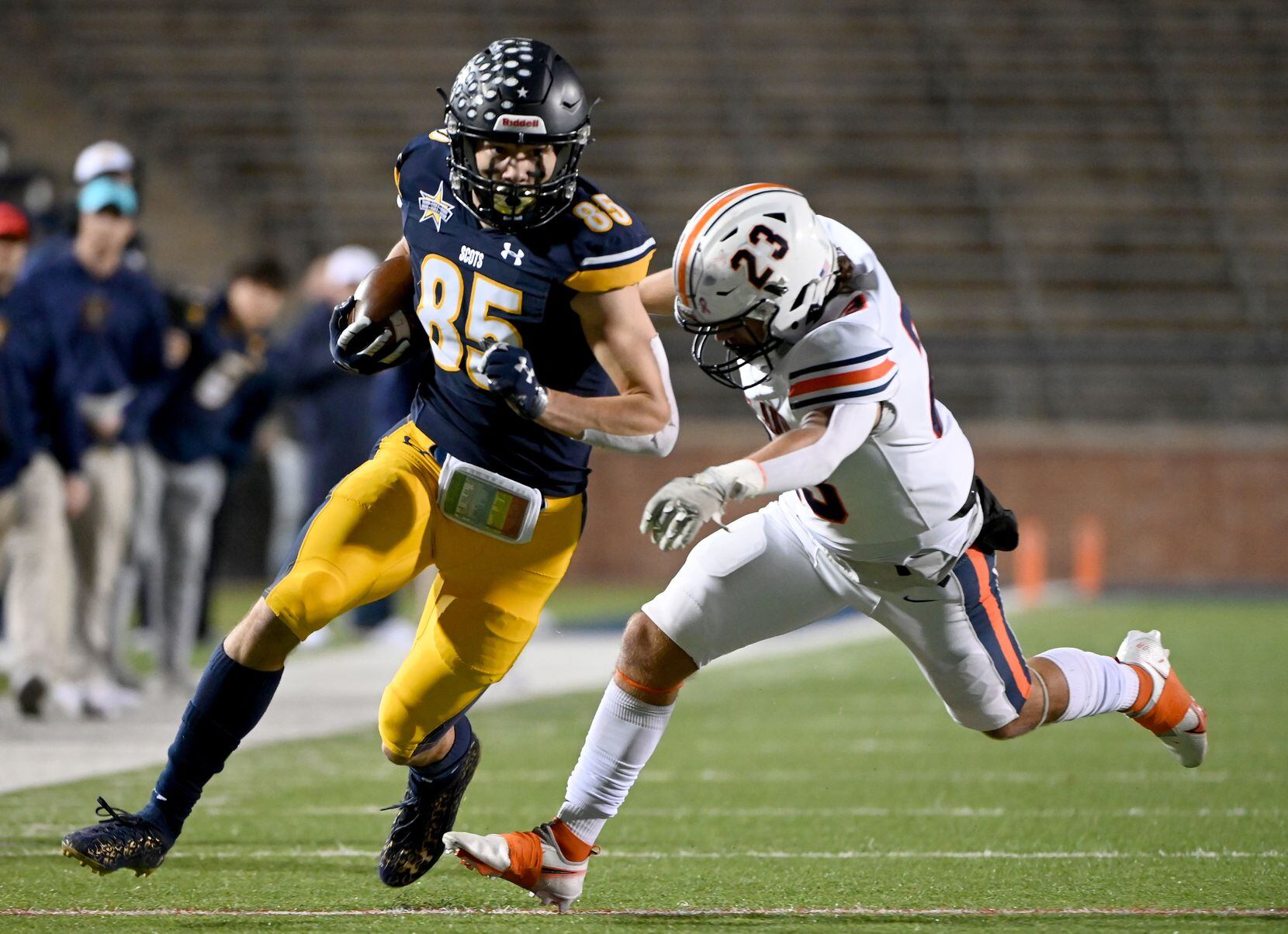 Highland Park’s Jackson Heis (85) tries to run through a tackle attempt by Wakeland's...