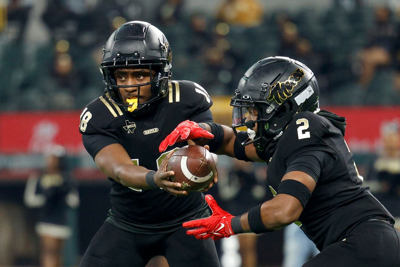 South Oak Cliff quarterback William Little (18) hands the ball to South Oak Cliff running...