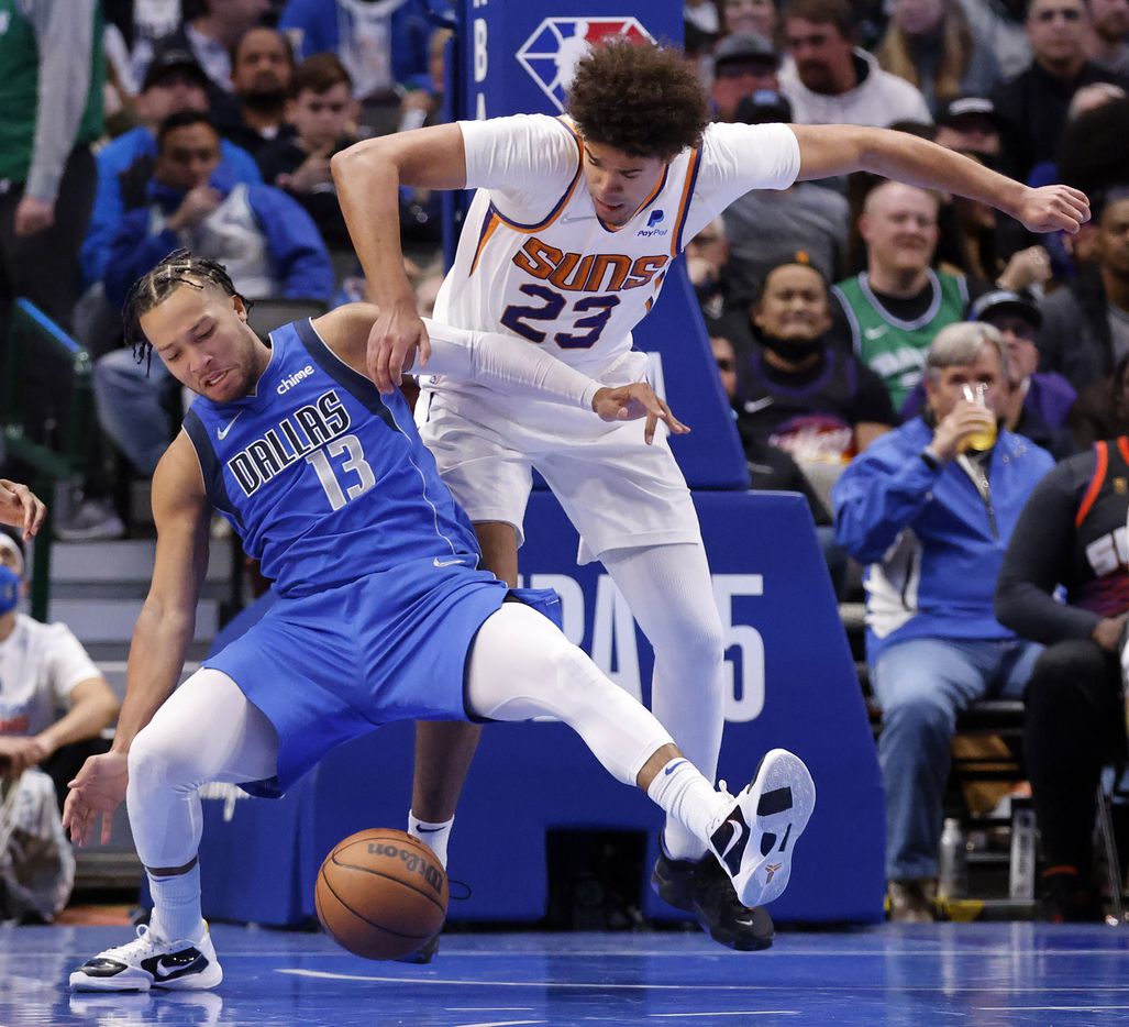 Dallas Mavericks guard Jalen Brunson (13) falls backward into Phoenix Suns forward Cameron...
