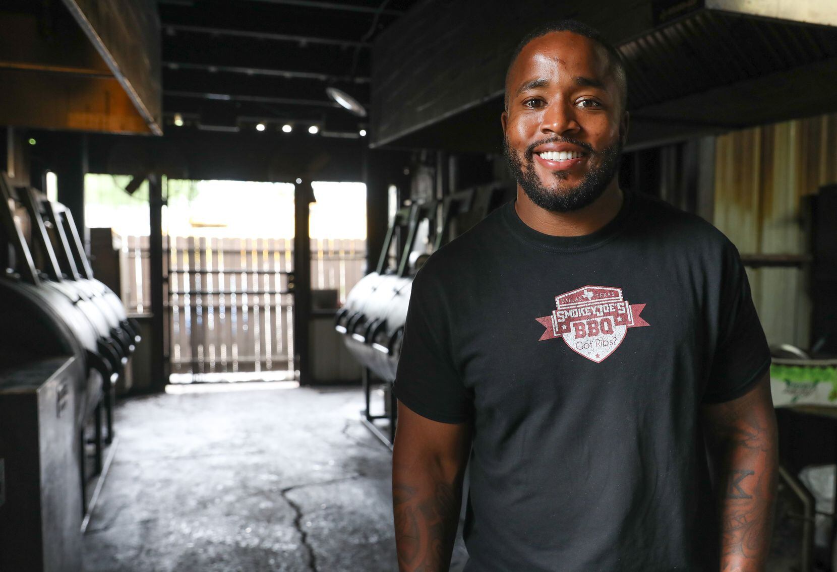 Owner Kris Manning stands by the Smokey Joe's BBQ pits in Dallas.