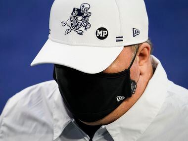 Dallas Cowboys head coach Mike McCarthy wears a sticker honoring strength and conditioning coach Markus Paul, who died Wednesday evening after having a medical emergency during Tuesday's practice, as he leaves the field for halftime of an NFL football game against the Washington Football Team at AT&T Stadium on Thursday, Nov. 26, 2020, in Arlington.