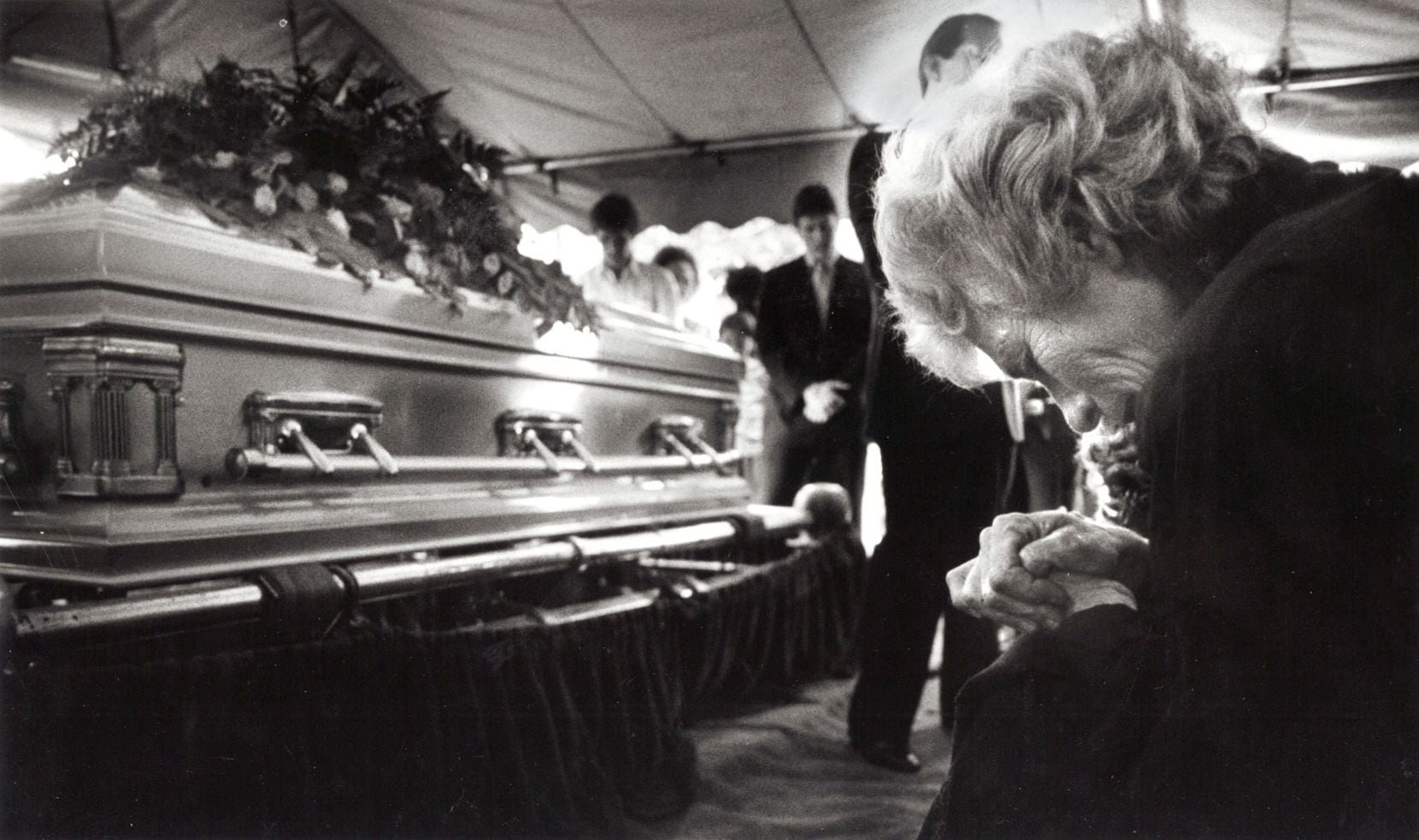 Doris Adkisson bows her head and prays for her son Mike Von Erich during his funeral...
