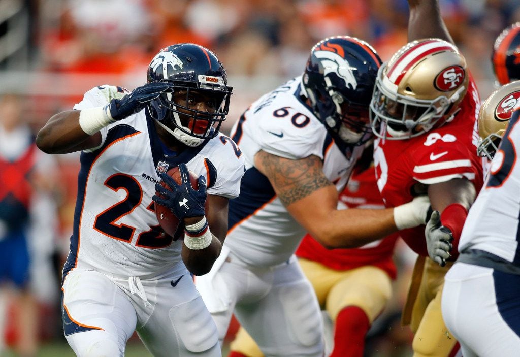 Denver Broncos running back C.J. Anderson (22) runs for a touchdown during the first half of...