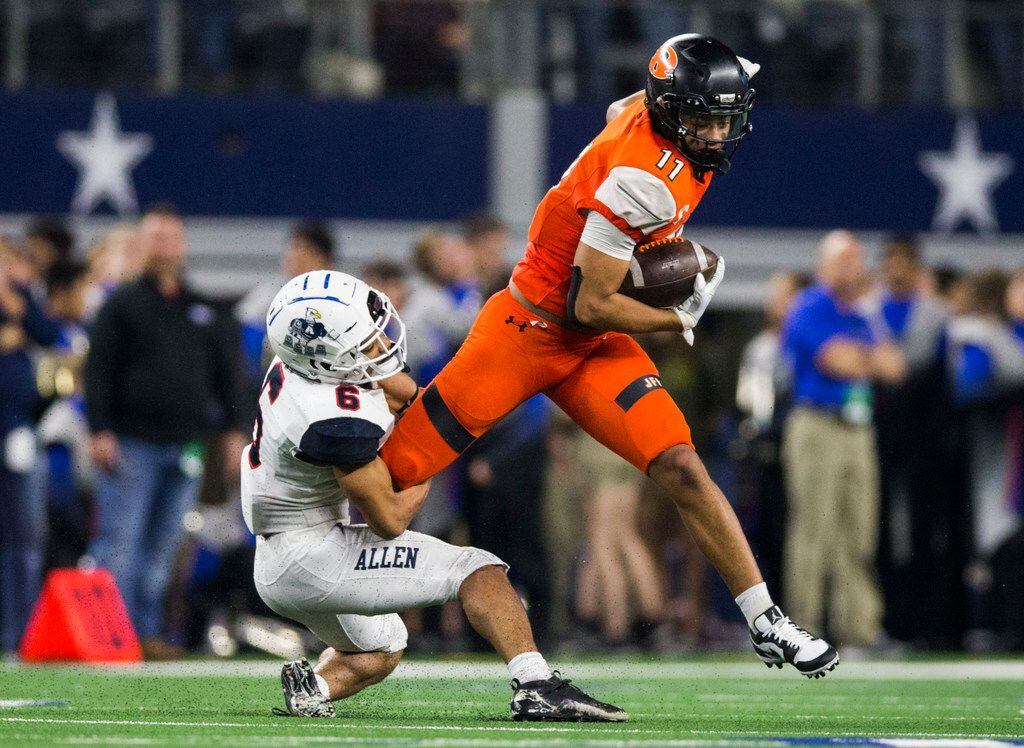 Rockwall wide receiver Jaxon Smith-Njigba (11) is tackled by Allen defensive back Matthew Norman (6) during the second quarter of a Class 6A Division I area-round high school football playoff game between Allen and Rockwall on Friday, November 22, 2019 at AT&T Stadium in Arlington. (Ashley Landis/The Dallas Morning News)