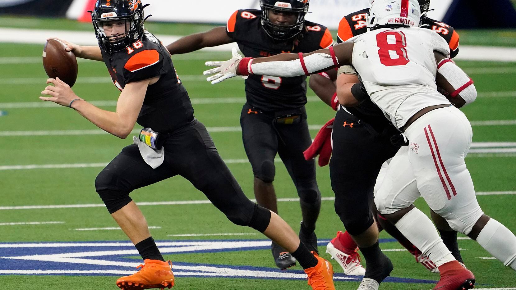 Aledo quarterback Brayden Fowler-Nicolosi (16) gets past Crosby defensive lineman Jeremiah Isaac (8) during the first half of the Class 5A Division II state football championship game at AT&T Stadium on Friday, Jan. 15, 2021, in Arlington. (Smiley N. Pool/The Dallas Morning News)